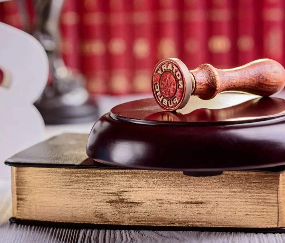 A wooden gavel sitting on top of a book.