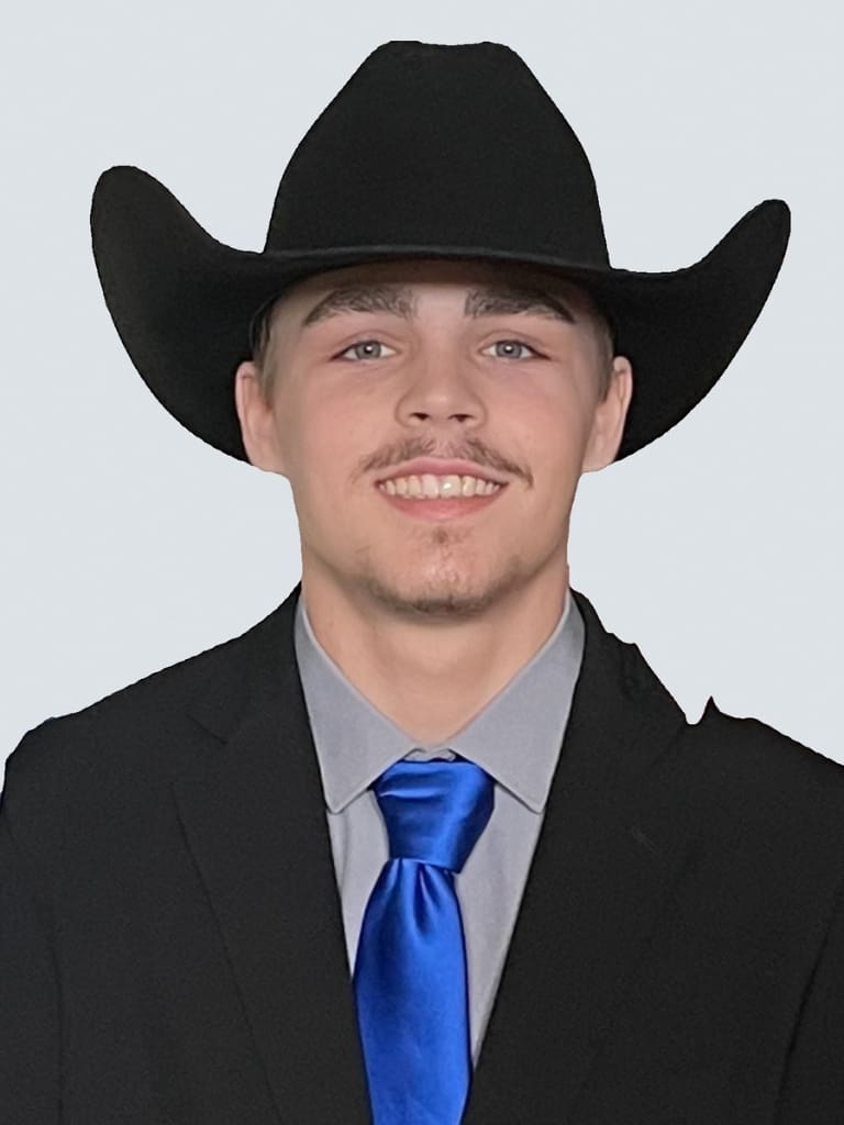 A man in a suit and tie wearing a cowboy hat.